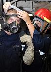 Workers putting on personal protective equipment