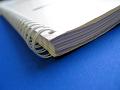 Spiral-bound document on blue surface